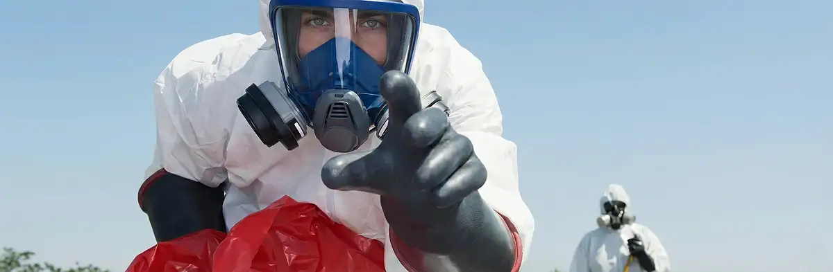 sewage clean up technician wearing protective gear handling biohazard materials in Glendale, AZ